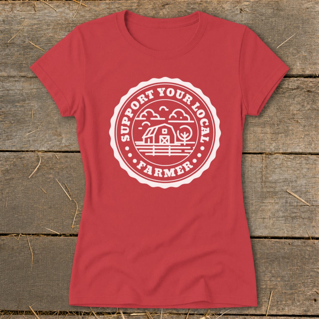 Red t-shirt with a white circular graphic featuring a barn and text "Support Your Local Farmer".