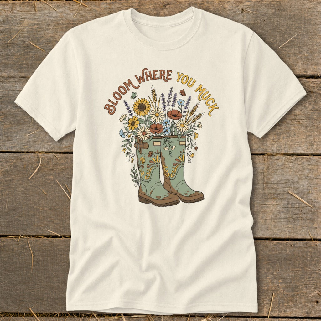 Cream t-shirt with boots overflowing with flowers and text "Bloom Where You Muck."