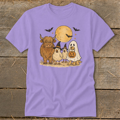 Highland cow, chickens, and dog in ghost costume with pumpkin, under a moon and bats.
