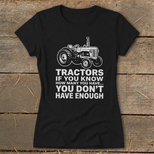 Black t-shirt with a tractor graphic and text: "Tractors if you know how many you have... You don't have enough."