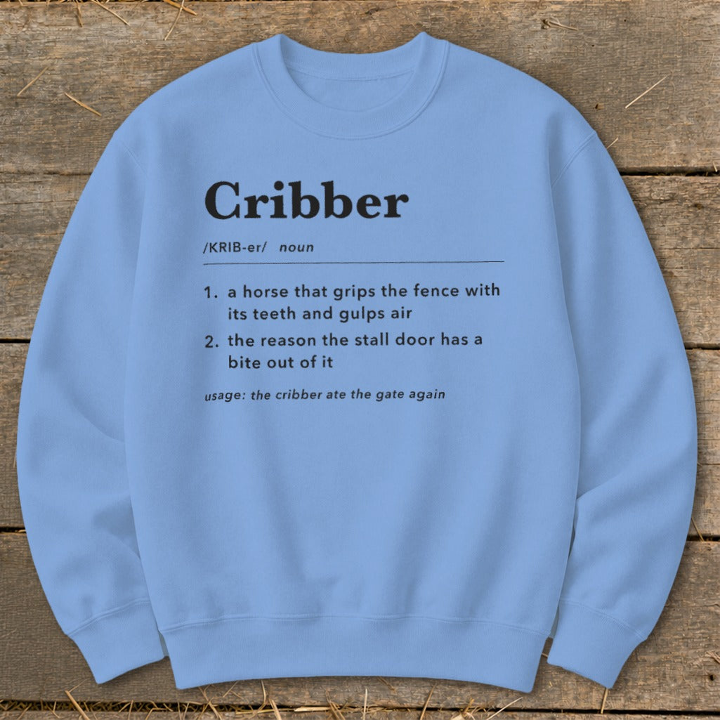 Light blue crewneck sweatshirt featuring a dictionary-style definition of the word cribber printed in black.