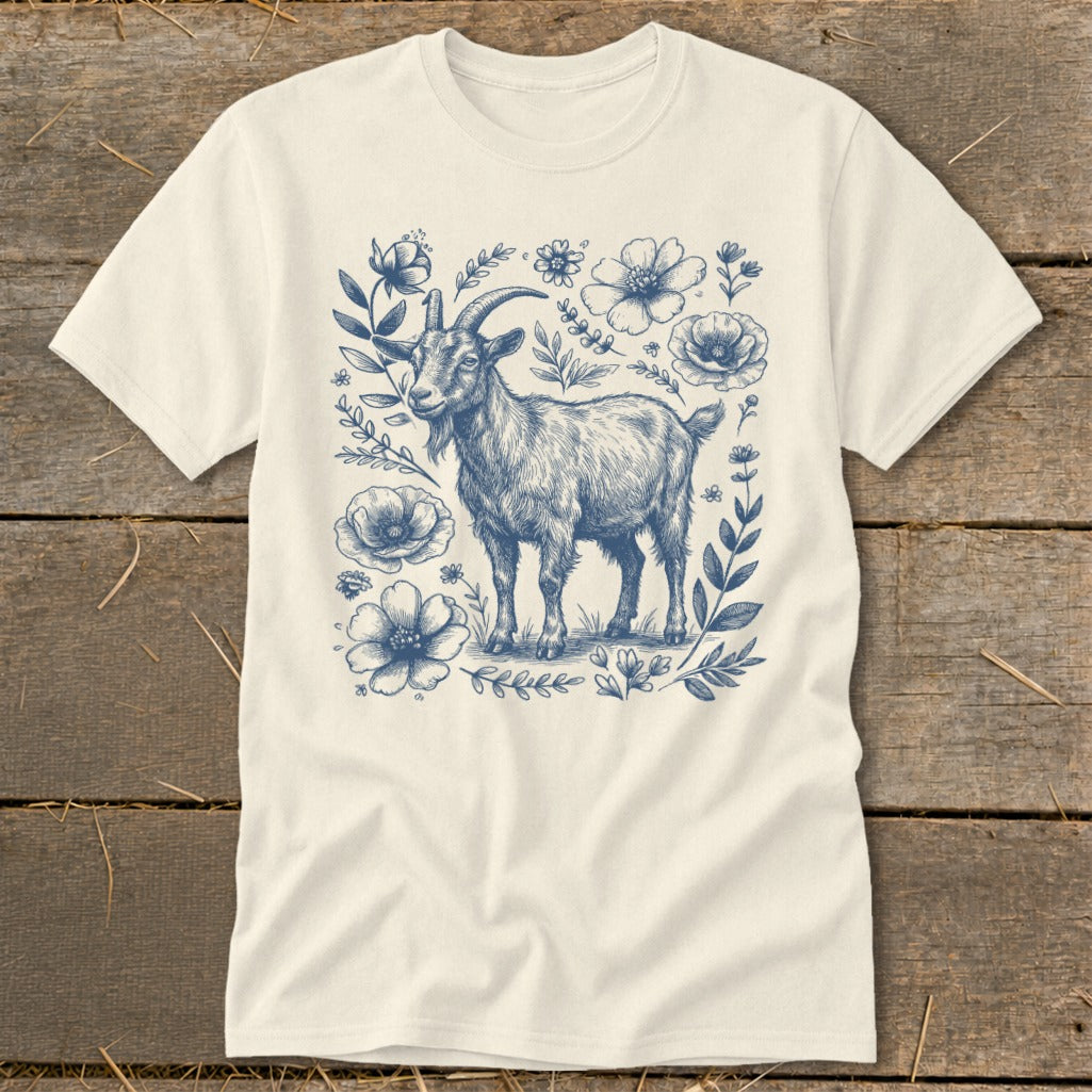 Cream t-shirt with blue illustration of a goat surrounded by floral elements.