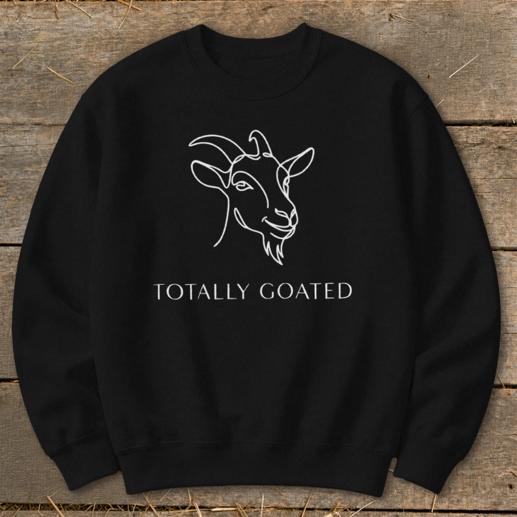 Black sweatshirt with white line art goat head and text "TOTALLY GOATED".