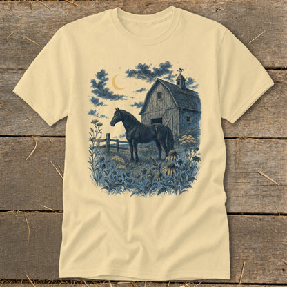 Horse in field with barn and crescent moon at night graphic on a cream t-shirt.