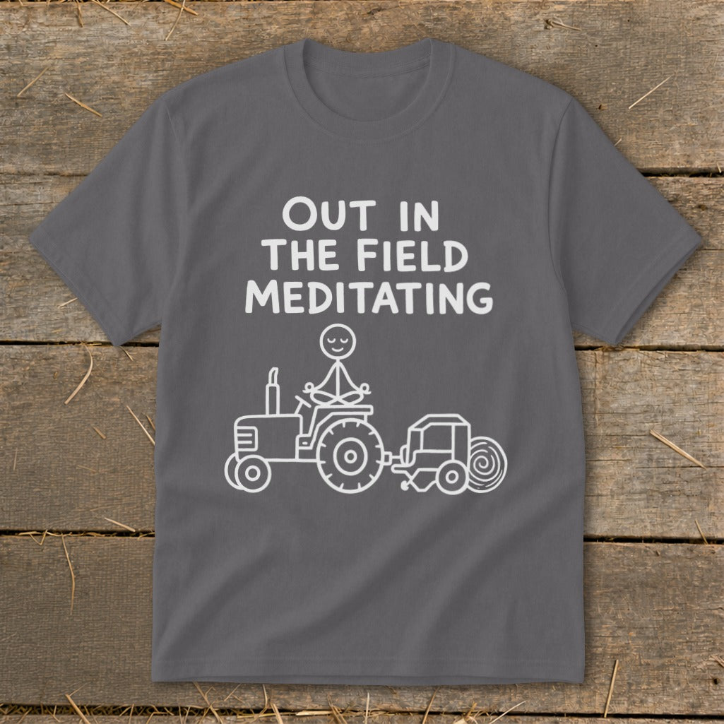T-shirt with white text and graphic of person meditating on a tractor.