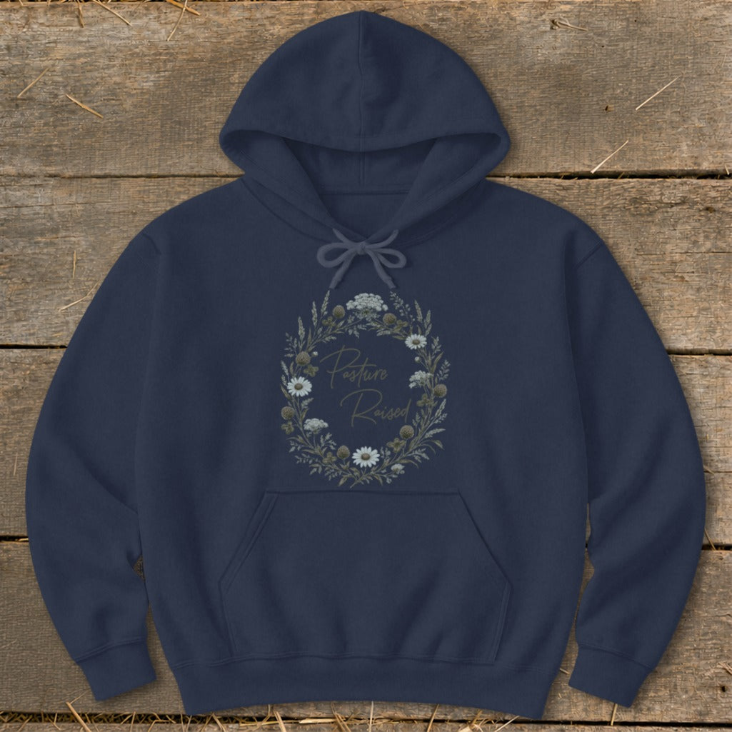 Navy blue hoodie with a floral wreath graphic and "Pasture Raised" text.