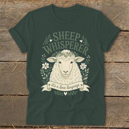 Dark green t-shirt with sheep illustration and "Sheep Whisperer it's a love language" text.
