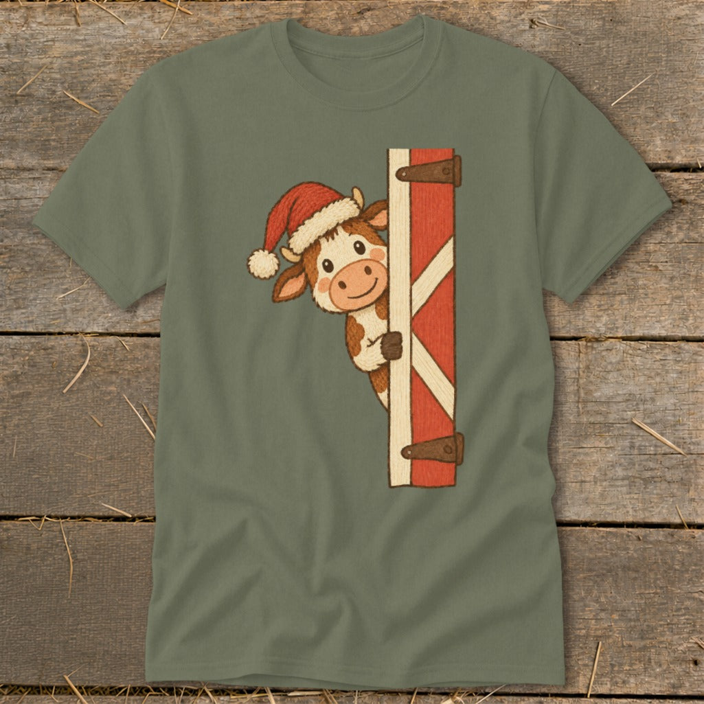 Cartoon cow wearing Santa hat peeking from behind a barn door.