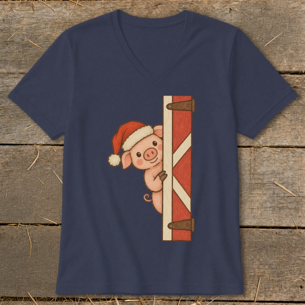 Pig in Santa hat peeking from barn door on navy t-shirt.