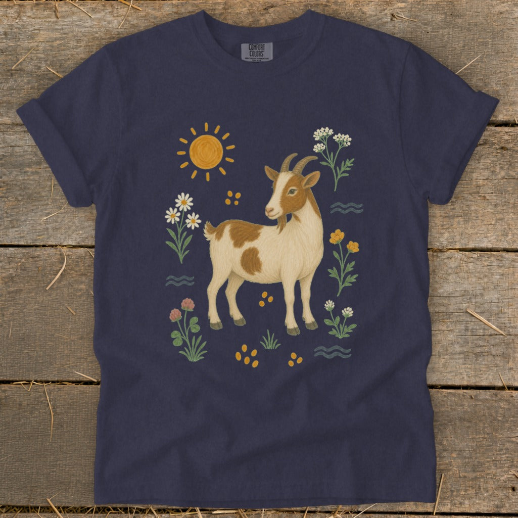 Navy t-shirt with a brown and white goat surrounded by flowers and sun.