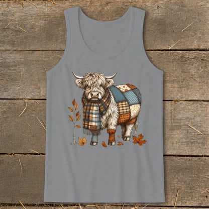 Highland cow with patchwork body, plaid scarf, and autumn leaves.
