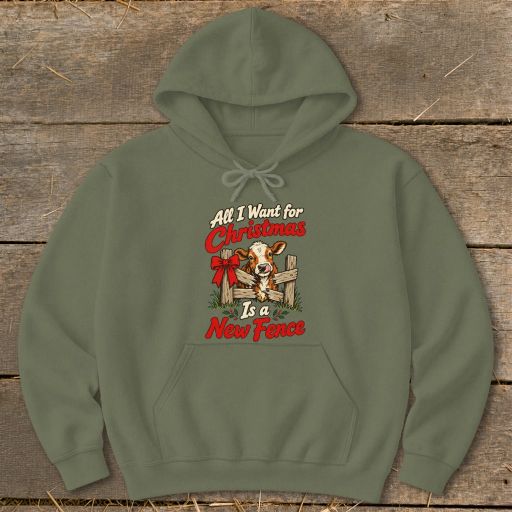 Olive green hoodie with a Christmas cow design and text "All I Want for Christmas Is a New Fence".