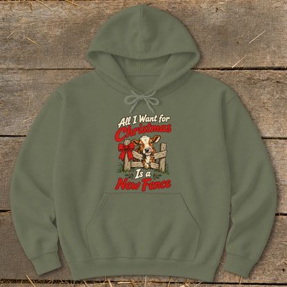 Olive green hoodie with a Christmas cow design and text "All I Want for Christmas Is a New Fence".
