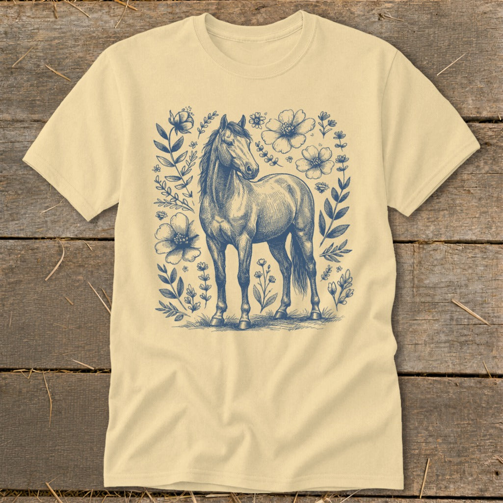Light yellow t-shirt with a blue ink sketch of a horse surrounded by flowers.