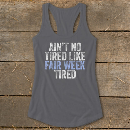 Grey tank top with "Ain't No Tired Like Fair Week Tired" text in white and blue.