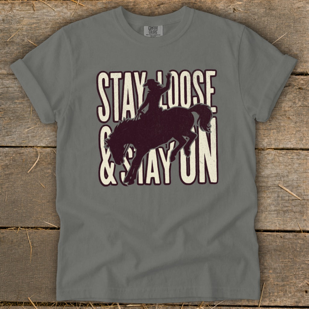 Grey t-shirt with "Stay Loose & Stay On" text and rodeo rider silhouette.