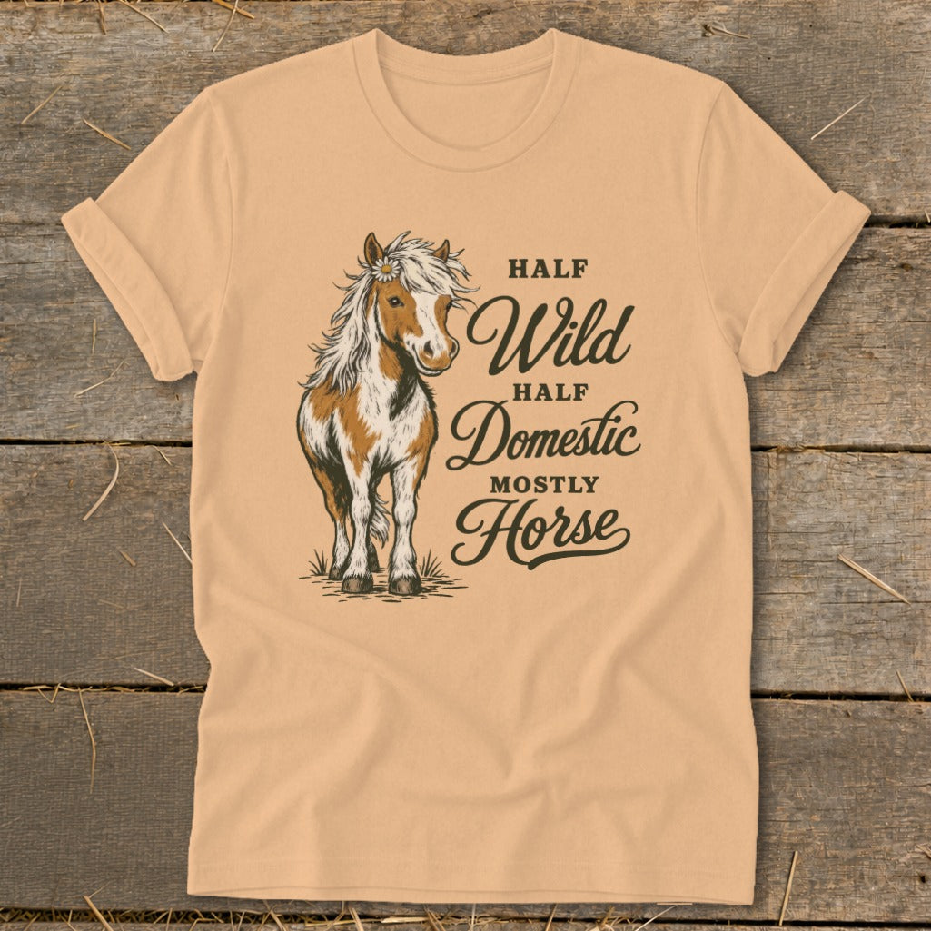 Peach t-shirt with a horse illustration and text "Half Wild, Half Domestic, Mostly Horse".