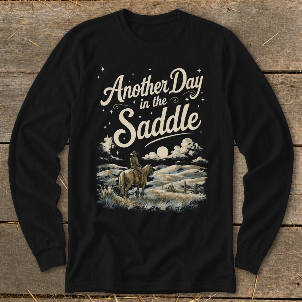 Black long sleeve shirt with "Another Day in the Saddle" text and cowboy on horseback.