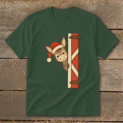 Christmas donkey peeking around barn door wearing Santa hat.