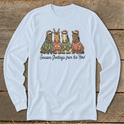 Light blue long-sleeve shirt with four horses wearing Christmas sweaters and hats.