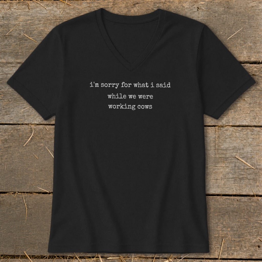 Black v-neck t-shirt with white text: "i'm sorry for what i said while we were working cows."