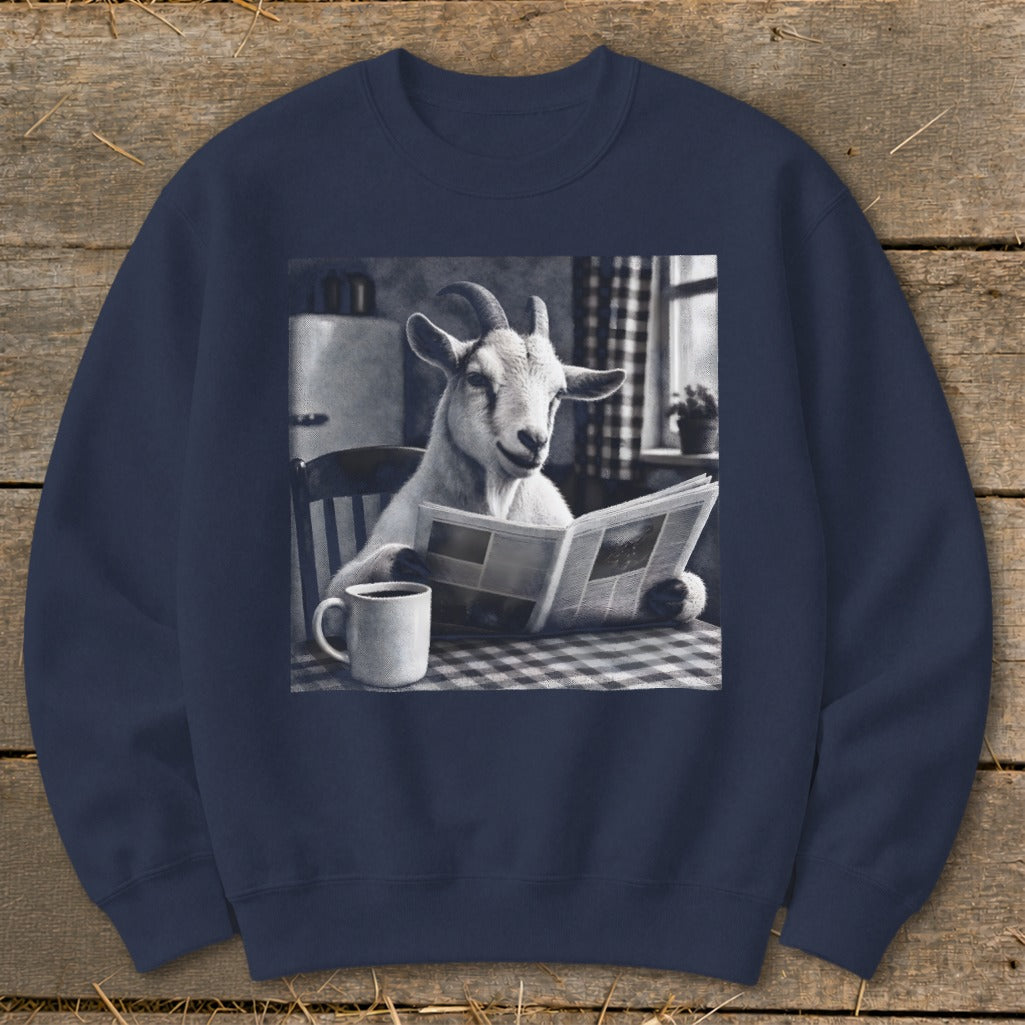 A dark blue crewneck sweatshirt featuring a graphic of a goat reading a newspaper at a kitchen table.