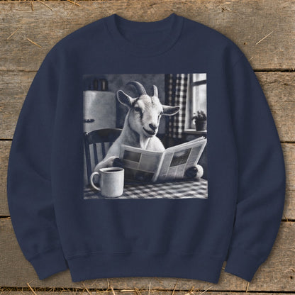 A dark blue crewneck sweatshirt featuring a graphic of a goat reading a newspaper at a kitchen table.