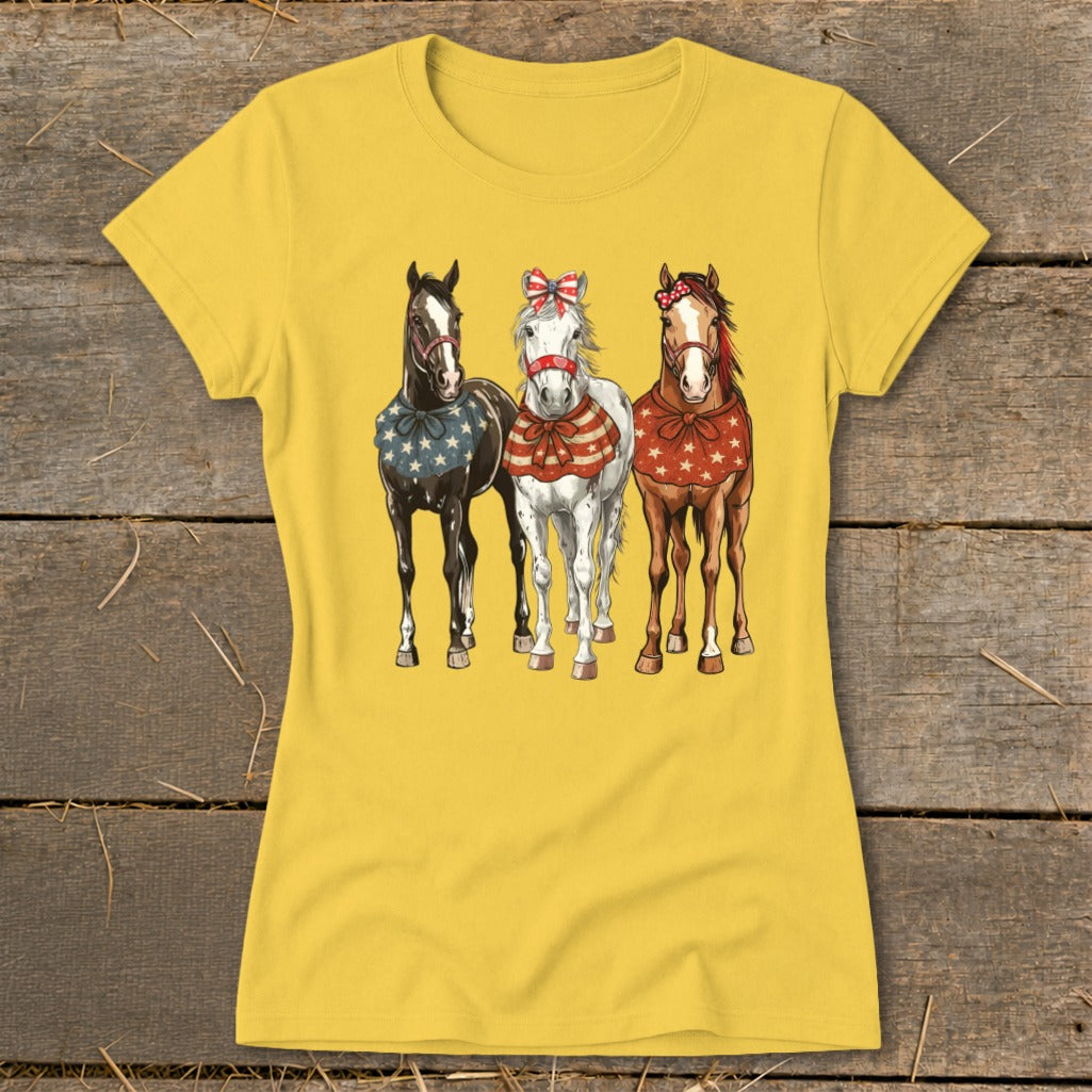 Three horses in patriotic attire stand side-by-side on a yellow t-shirt.