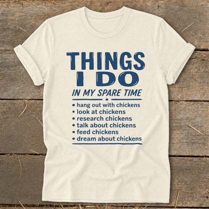 Cream t-shirt with "Things I Do In My Spare Time" and chicken-related activities.