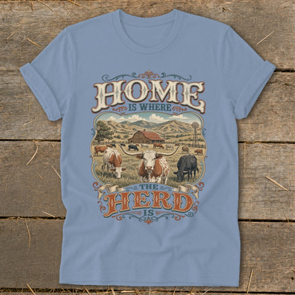 Light blue t-shirt with "HOME IS WHERE THE HERD IS" phrase and farm scene.