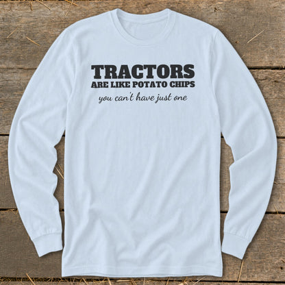 Light blue long-sleeve shirt with black text: "Tractors are like potato chips you can't have just one".