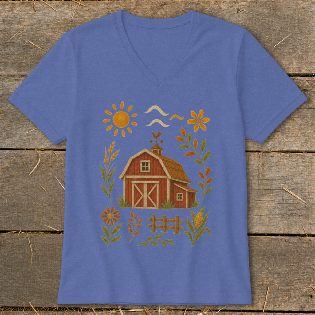 Blue t-shirt with a whimsical farm scene illustration featuring a red barn and sun.
