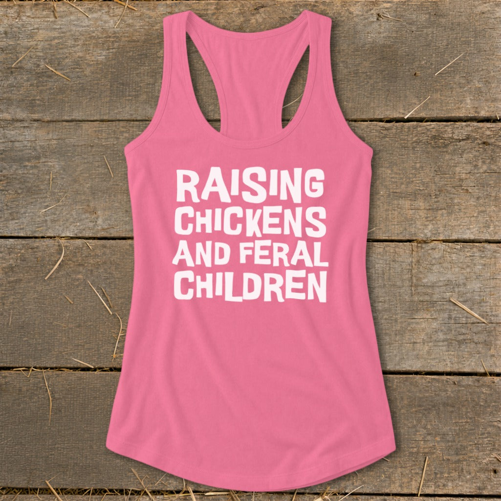 Pink tank top with white text reading "RAISING CHICKENS AND FERAL CHILDREN".