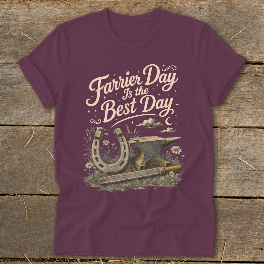 Maroon t-shirt with a graphic of a horseshoe, anvil, rasp, and flowers with text "Farrier Day Is the Best Day".