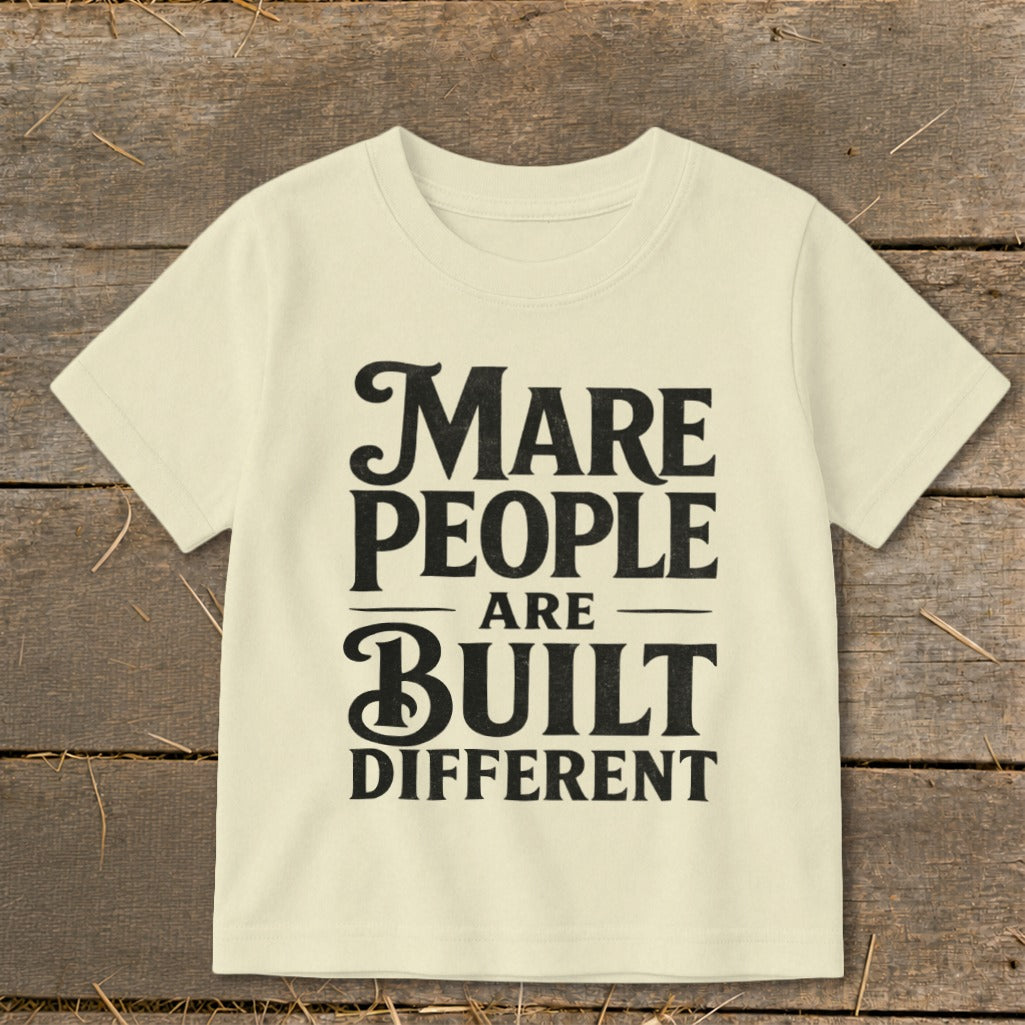 Light yellow t-shirt with black text: "Mare People Are Built Different"