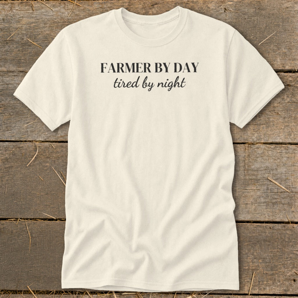 Cream t-shirt with black text reading "FARMER BY DAY tired by night".