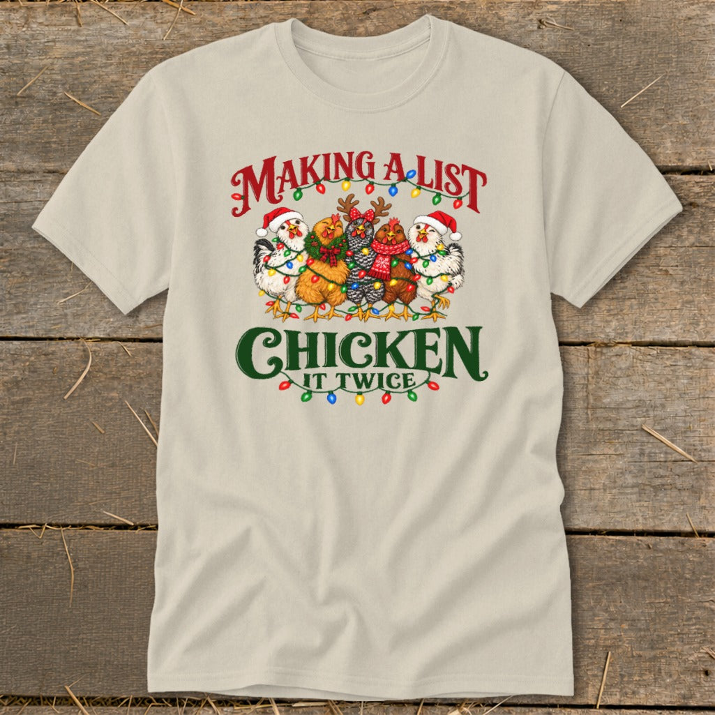 T-shirt with cartoon chickens in Santa hats and festive lights, reads "Making a list, chicken it twice."