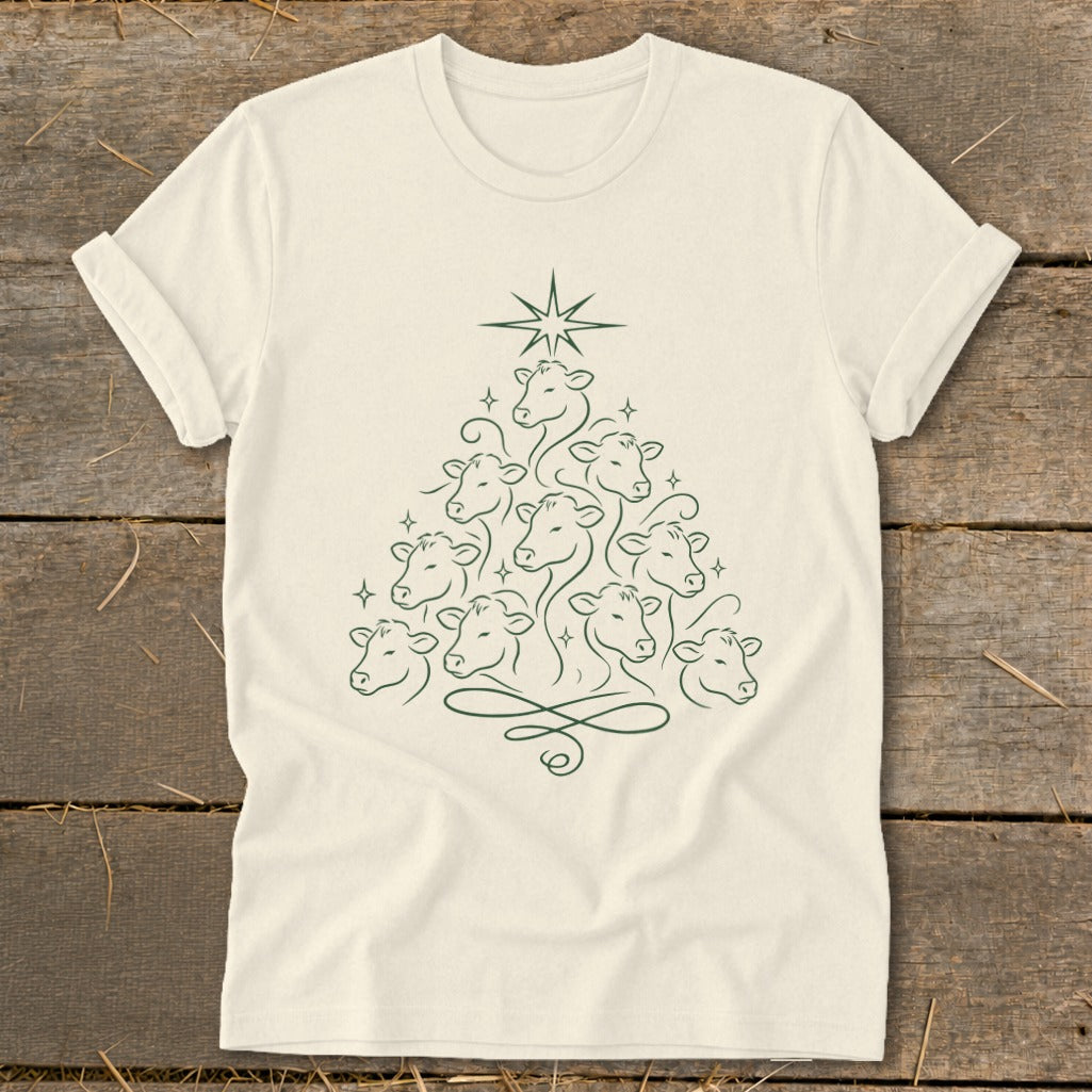 Cream t-shirt with a Christmas tree made of cows and a star.