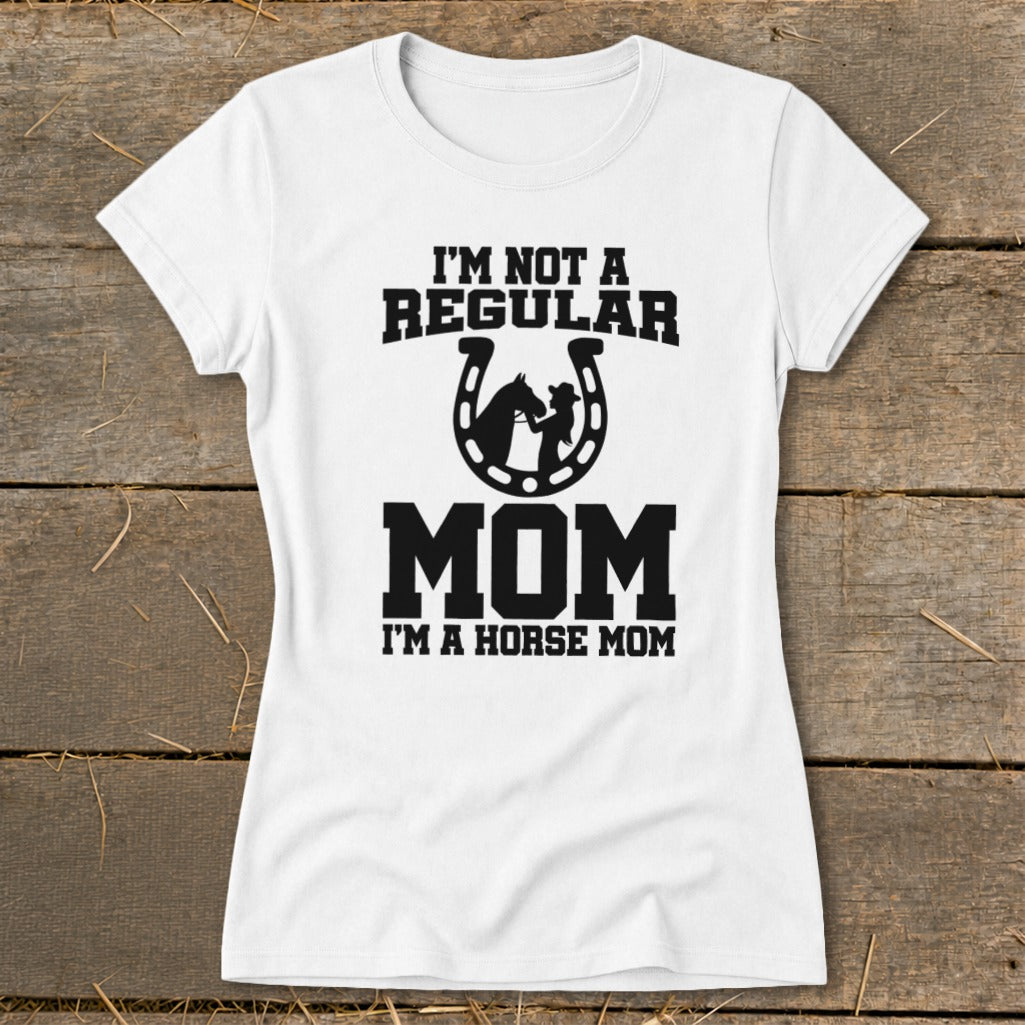 White t-shirt with text "I'M NOT A REGULAR MOM I'M A HORSE MOM" and horseshoe graphic.