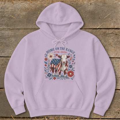 Cow with American flag draped over its back surrounded by flowers and text.