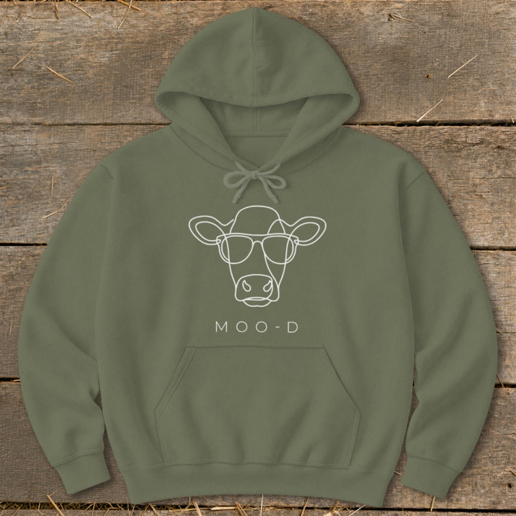 Olive green hoodie with white line art of a cow wearing glasses and the text MOO-D.