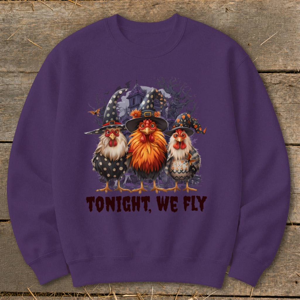 Three chickens in witch hats stand before a haunted house with text "TONIGHT, WE FLY".