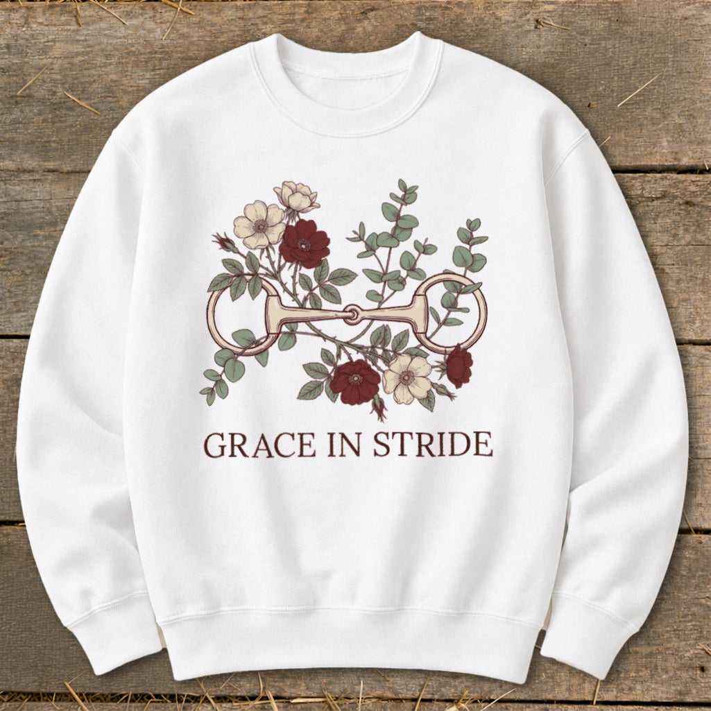 White sweatshirt with a floral horse bit graphic and text "GRACE IN STRIDE."