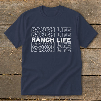Navy blue t-shirt featuring repeated white outline text that reads RANCH LIFE on a wooden background.