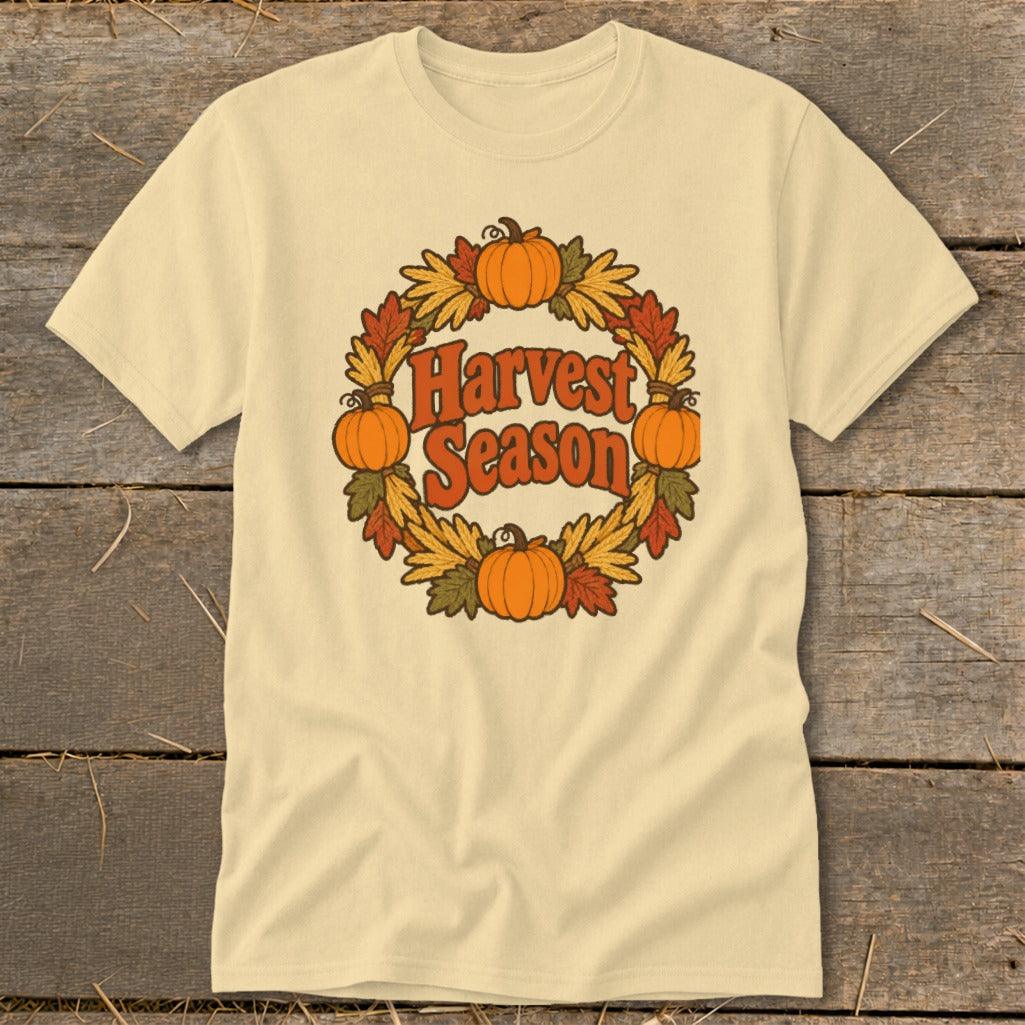 Cream t-shirt with "Harvest Season" in a wreath of pumpkins and fall leaves.