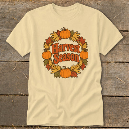 Cream t-shirt with "Harvest Season" in a wreath of pumpkins and fall leaves.