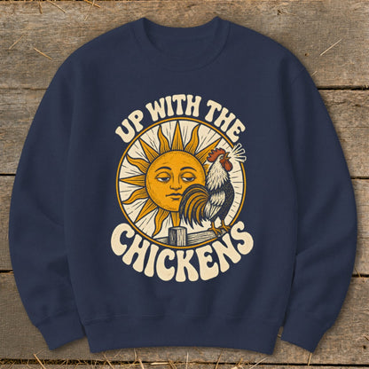 A navy blue crewneck sweatshirt featuring a graphic of a rooster, a smiling sun, and the text Up With The Chickens.