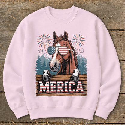Horse wearing American flag sunglasses with "MERICA" sign and fireworks.