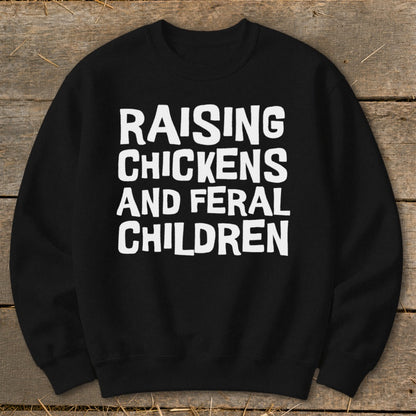 Black sweatshirt with white text "RAISING CHICKENS AND FERAL CHILDREN".