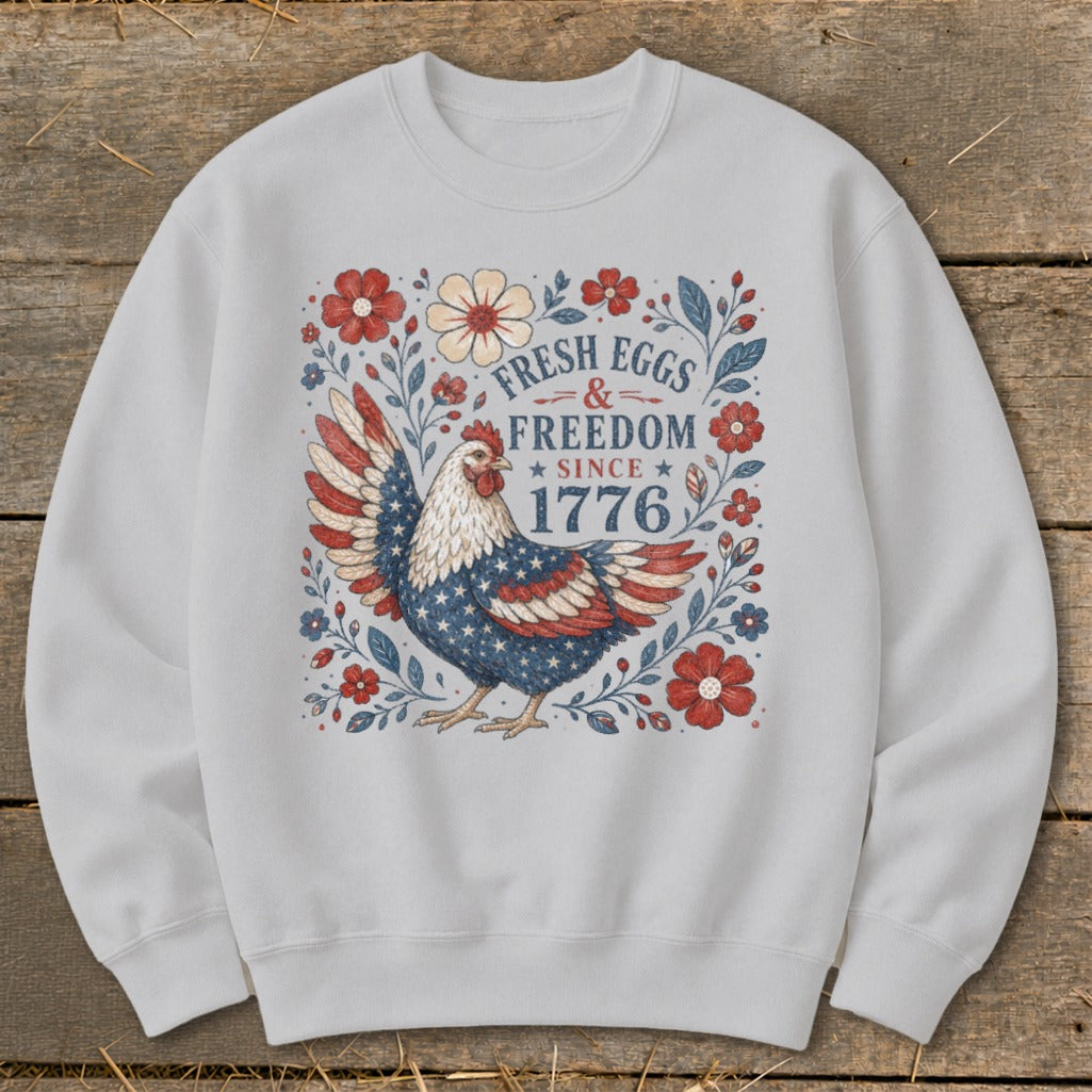 Chicken with American flag wings surrounded by flowers and text "Fresh Eggs & Freedom Since 1776".